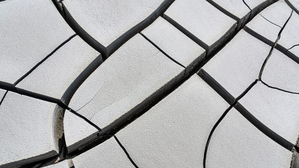 Close-up of a cracked, weathered surface showing multiple fractures.