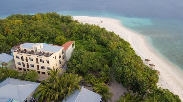 guesthouse viewed from above, surrounded by ocean